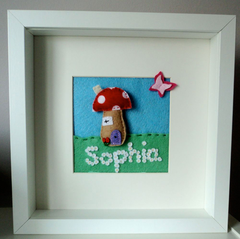 Felt Box Frame — Mounted & personalised. Hand cut felt toadstool which is slightly padded, with a flower lined path and a 3D butterfly in a 10 inch squared box frame, mounted so that the picture is 4½ inches square. Each flower, butterfly, toadstool is hand cut and hand stitched by me and is very labour intensive. This is just an example of the pictures I can do. Prices for these start at £20 depending on the size of the picture and the level of detail required. This one is £26. Felt Box Frame — Mounted & personalised. Hand cut felt toadstool which is slightly padded, with a flower lined path and a 3D butterfly in a 10 inch squared box frame, mounted so that the picture is 4½ inches square. Each flower, butterfly, toadstool is hand cut and hand stitched by me and is very labour intensive. This is just an example of the pictures I can do. Prices for these start at £20 depending on the size of the picture and the level of detail required. This one is £26.